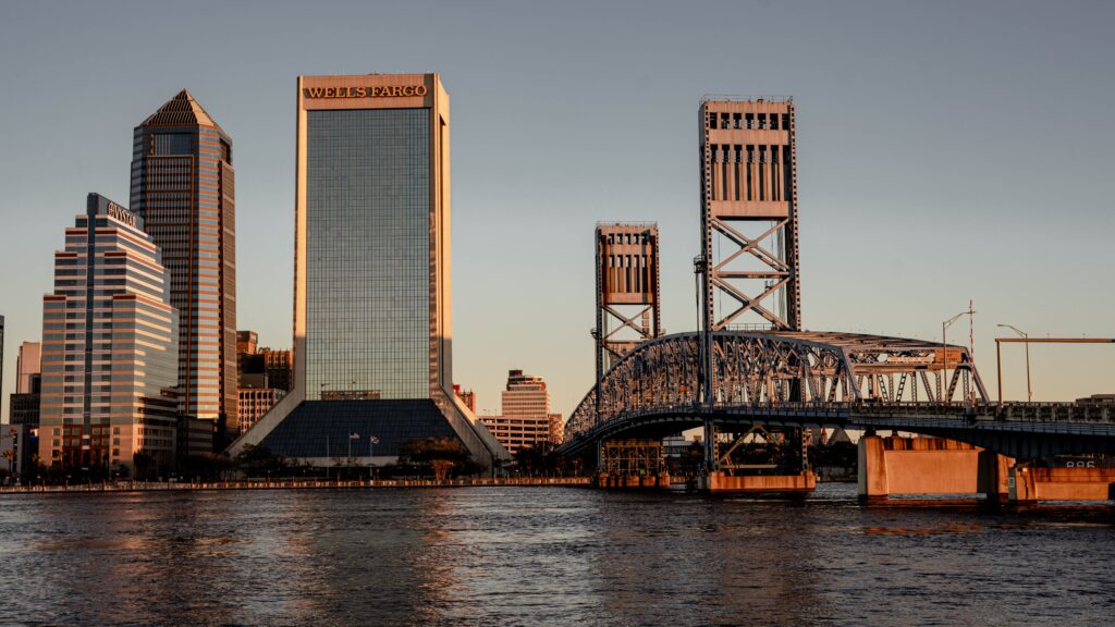 Jacksonville FL skyline at sunset with bridges reflecting on the St. Johns River